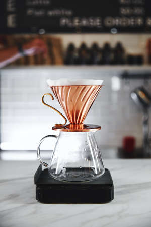 The V60 hario coffee dripper, devices for coffee in the background, close upの写真素材