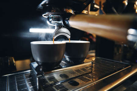 Close up photo of espresso machine working with bar interior backgroundの写真素材