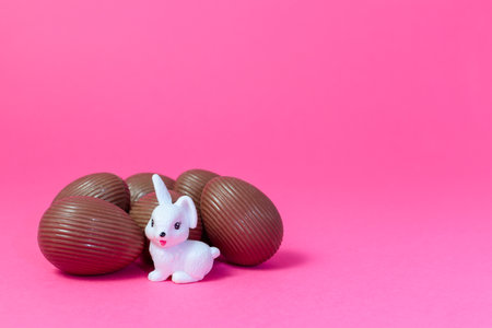 White rabbit watching over bunch of chocolate eggs Easter Holiday Concept.jpgの写真素材