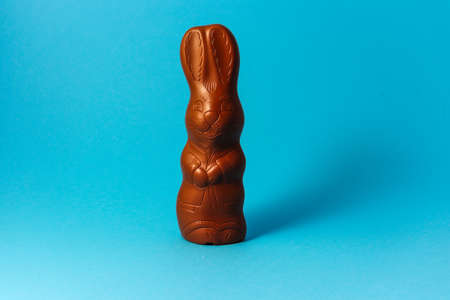 Easter Chocolate Bunny on Blue Background Creative Easter Holiday Conceptの写真素材