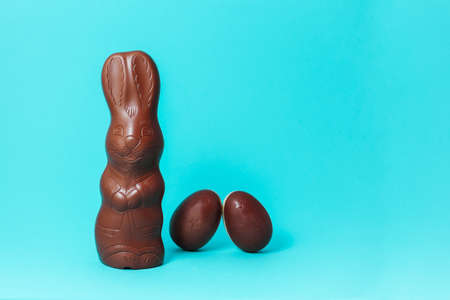 Easter Chocolate Bunny with Eggs on Turquoise Background Creative Easter Holiday Concept.jpgの写真素材