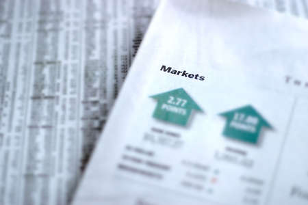 Newspaper showing daily market report. Shallow depth of field with focus on の写真素材