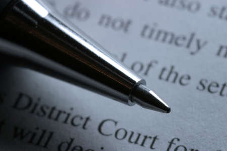 Close-up of a fine ballpoint pen and court document. Shallow depth of field.の写真素材