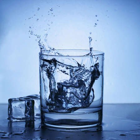 Ice splashing into a glass.の写真素材