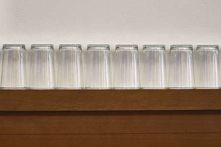 Row of empty glasses on shelfの写真素材