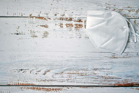 Medical face masks on wood background. Protection against coronavirus, flu and other airborne infection.の写真素材
