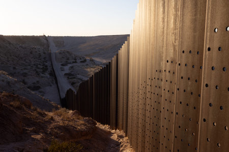 Abandoned metal fence in the desert at sunset, horizontal aspect