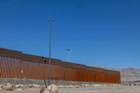 Huge iron fence on a bright sunny day with blue sky.