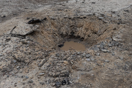 Mud hole in the ground, close-up of mud hole