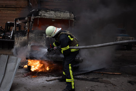 Firefighters extinguish a fire at a burning building in the city.