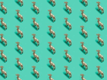 Christmas, trendy pattern, isometric photography, Golden reindeers, green isolated background, winter, autumn, Minimal Christmas or New Year concept.の写真素材