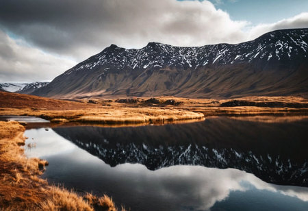 Icelandic landscape with reflection of mountains and clouds on the waterの素材