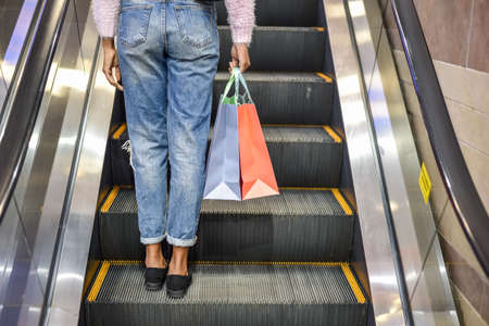 black Woman shopping with bags in a shopping center.の写真素材