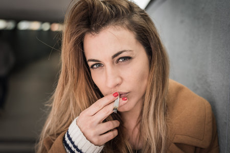 beautiful young woman smoking cigarette
