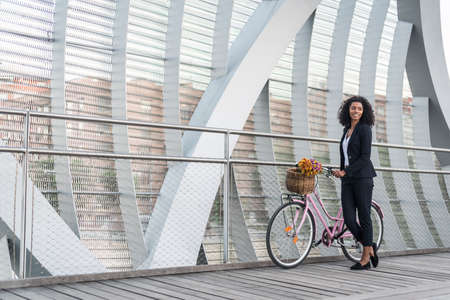 Business woman with vintage black bicycle in a bridge.の写真素材