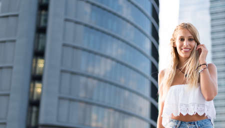 happy beautiful blonde woman smiling looking at the camera and posing.の写真素材