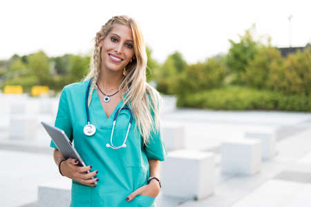 Female doctor, nurse or vet outdoors smiling looking at the camera isolated portrait closeup.の写真素材