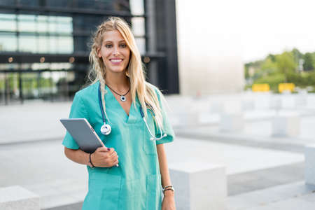 Female doctor, nurse or vet outdoors smiling looking at the camera isolated portrait closeup.の写真素材