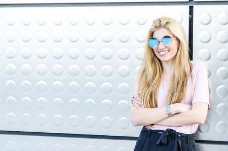 happy blonde young woman smiling isolatedの写真素材