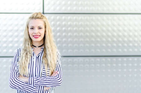 happy blonde young woman smiling isolatedの写真素材