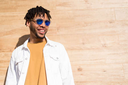 young american man smiling happy with sunglasses portrait outdoorの写真素材