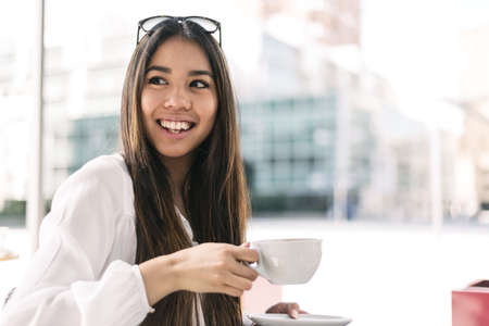 young woman close up portrait with coffeeの写真素材