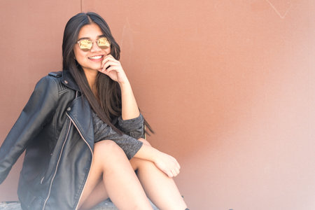 happy young woman portrait close up smiling with sunglassesの写真素材
