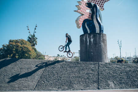 street biker practicing free style with a bicycle and jumping  at the street の写真素材