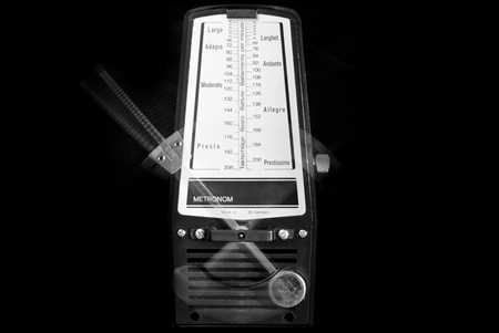 Mechanical metronome working with black backgroundの写真素材