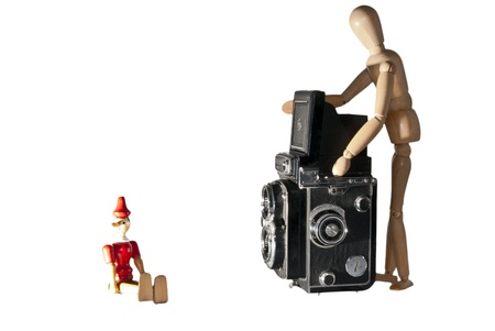 Photographer doll working with a model in studioの写真素材