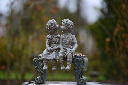 Kissing boy and girl on benchの写真素材