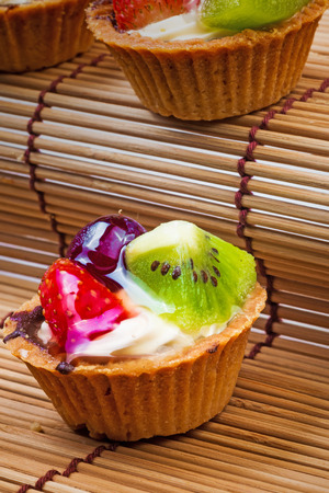 Mini fruit tart and wooden backgroundの写真素材