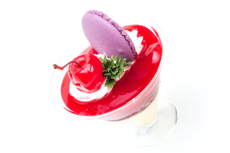 Strawberry shot cake with cherry and macaronの写真素材