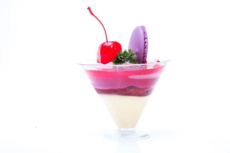 Strawberry shot cake with cherry and macaronの写真素材