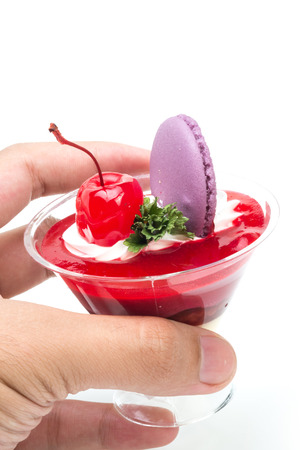Strawberry shot cake with cherry and macaronの写真素材