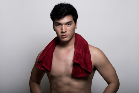 Asian man with towel in the handの写真素材