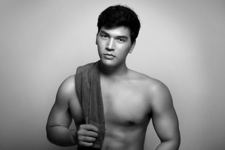 Asian man with towel in the handの写真素材