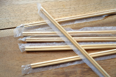 package of readymade bamboo chopsticks on wooden background