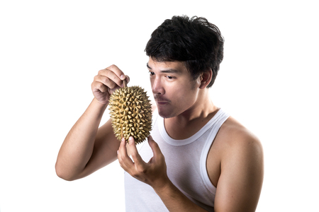 Asian man with bad smell of durian in white backgroundの写真素材