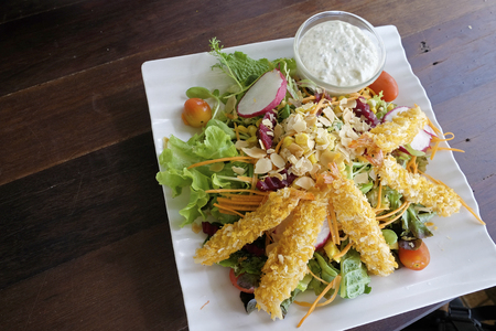 Fresh vegetable salad with tempura on the topの写真素材