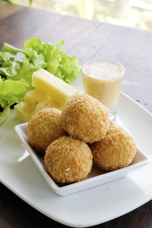 Fried cheese ball with salad in the dishの写真素材