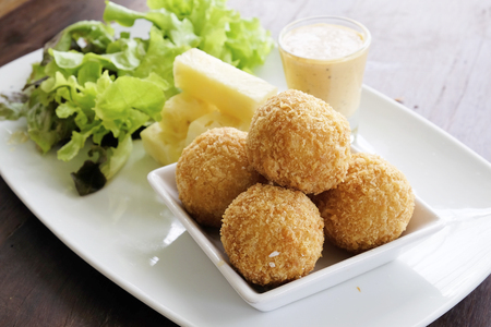 Fried cheese ball with salad in the dishの写真素材