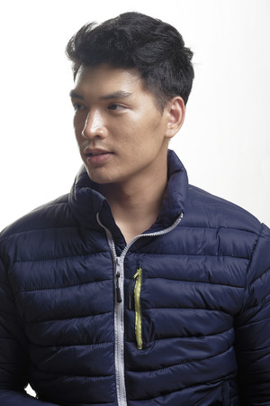Portrait of Asian man in the down coatの写真素材