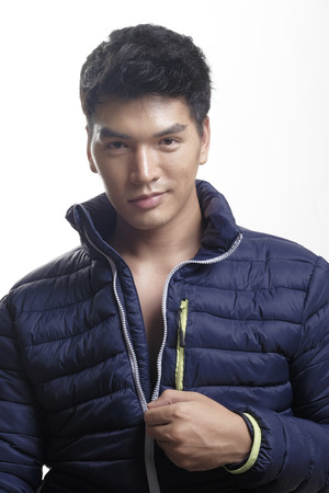 Portrait of Asian man in the down coatの写真素材