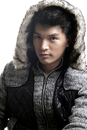 Asian man in fur and yarn texture jacketの写真素材