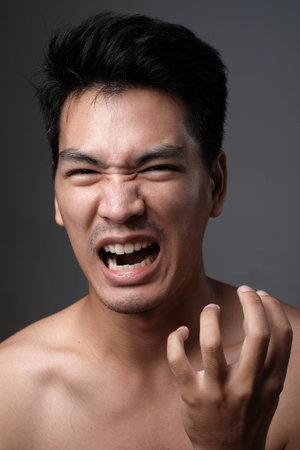 Asian man portrait with no makeup show his real skin in grey background - soft focus