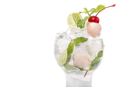 Lychee cocktail with mint leaves, lime and cherry decoration in whiteの写真素材