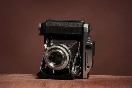 vintage rangefinder film folding camera on brown backgroundの写真素材
