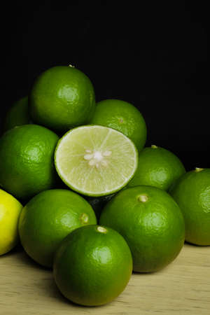 Green limes on the wooden tableの写真素材