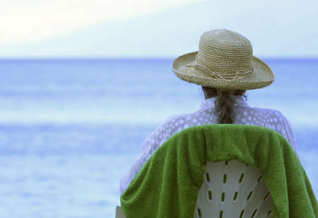 Senior Woman Sitting on Beachの写真素材